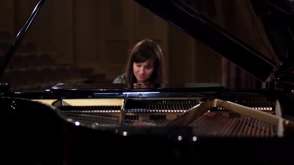 Girl Playing the Piano in the Concert Hall