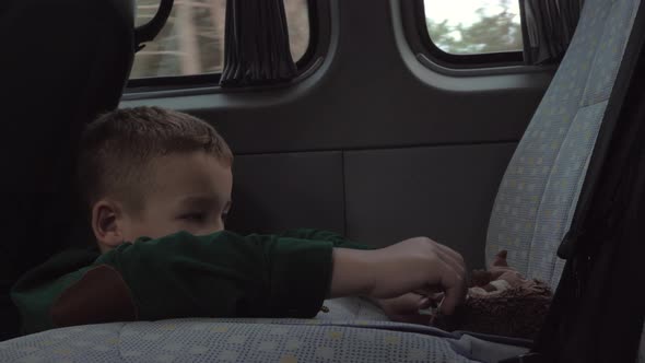 Child playing with toys during car journey