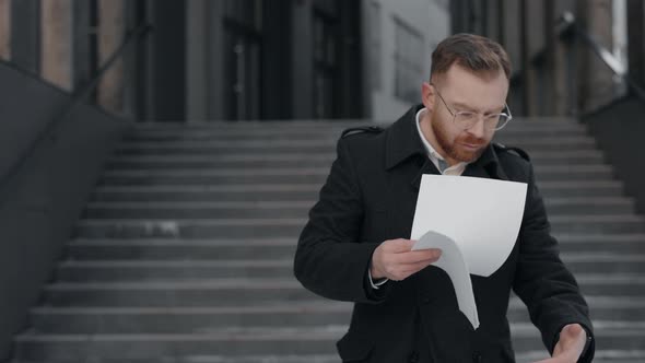 Businessman Reading Some Documents Looking Serious