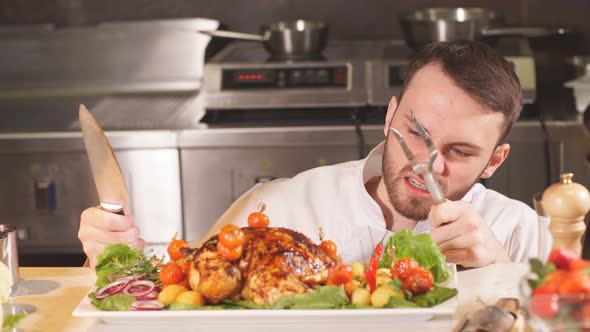 Young Chef with a Frenzied Look Wants To Cut a Cooked Dish