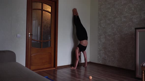 Young Woman with Long Hair Fitness Instructor in Black Sportswear Doing Stretching and Pilates on