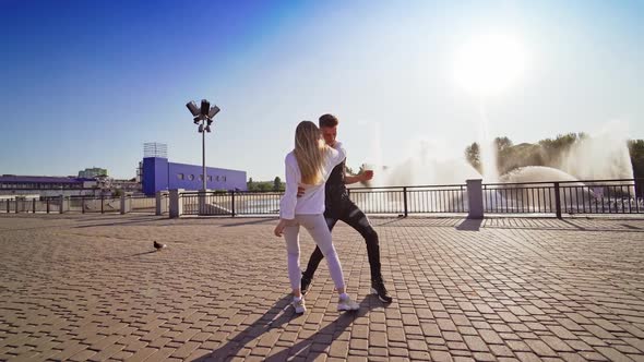 Modern dancers are dancing in the street.