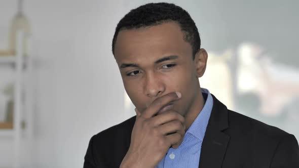 Depressed Casual AfroAmerican Businessman Thinking About Problems in Office