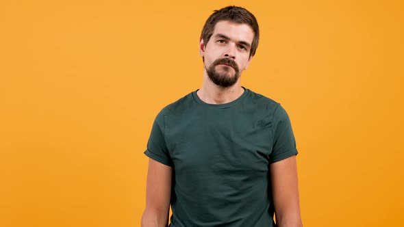 Bored Man Wearing a Casual Green T-shirt and Chewing Gum