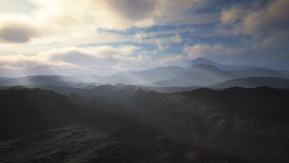 Black Volcanic Dust and Mountains with Fog in Background alt