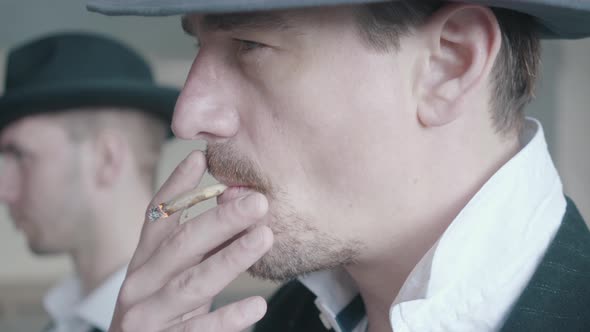 Close Up Portrait of Two Smoking Gangsters Walking in the Old Dilapidated Building