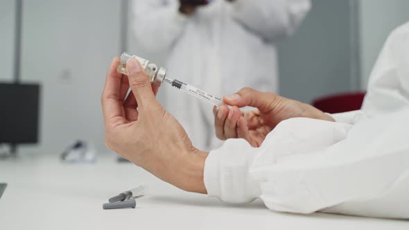 Close up of Caucasian team researcher holding the COVID vaccine on laboratory before test on human.