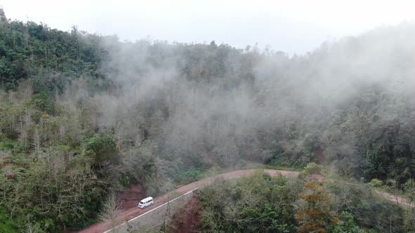 Traveling by Van Through the Foggy Jungle