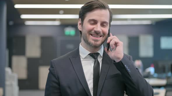 Portrait of Businessman Talking on Phone