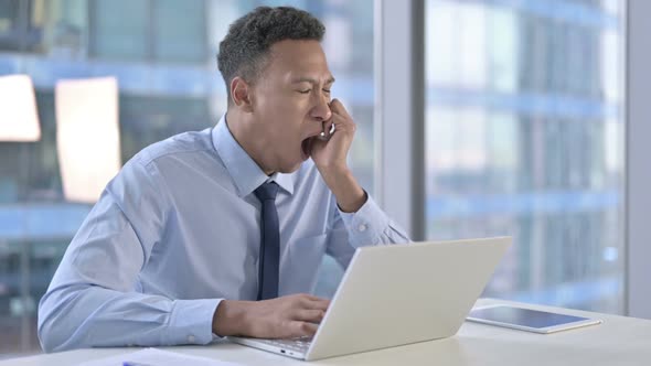 Sleepy African American Businessman Having Quick Nap on Office Table