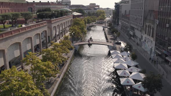 Massive touristic canoes sailing through canal of Aveiro city in Portugal, aerial view