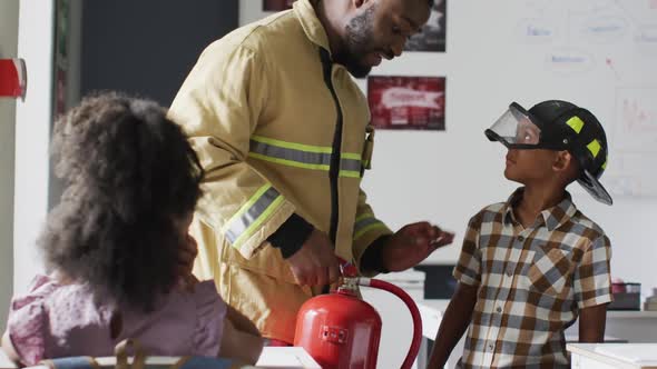 Video of happy african american teacher with class of diverse pupils during ohs lesson alt