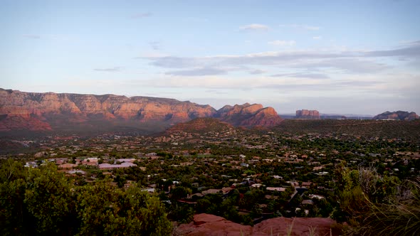 The majestic view of red rock mountains catching pink light over Sedona.