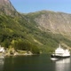 Ship Sailing Past Small Village In Norway Fjords - VideoHive Item for Sale