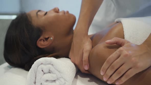 Young Woman Lying on Massage Bed in Spa Salon on