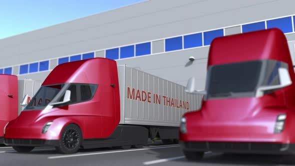 Modern Trucks with MADE IN THAILAND Text at Warehouse