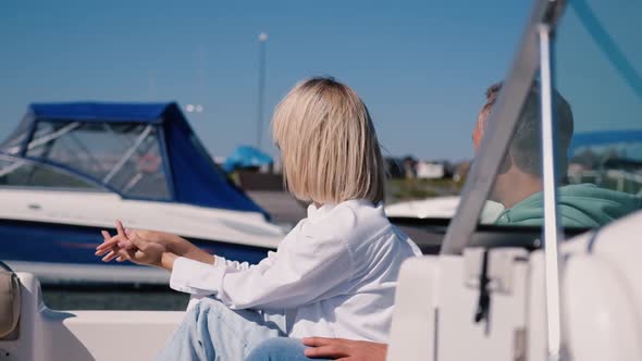 An Adult Couple in Love Ride a Speedboat in the Sea