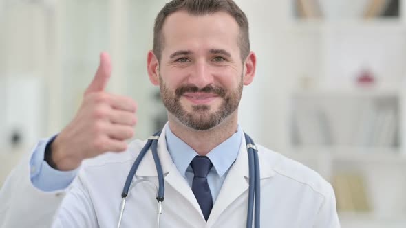 Portrait of Positive Male Doctor Showing Thumbs Up