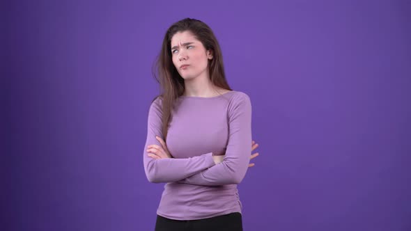 The Angry Young Woman Crosses Her Hands Over Her Chest and Looks Upset in Parts