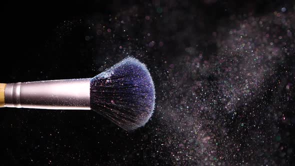 Make Up Brush with Colored Blue Powderon at Black Background Slow Motion