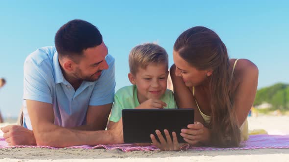 Happy Family with Tablet Computer on Summer Beach