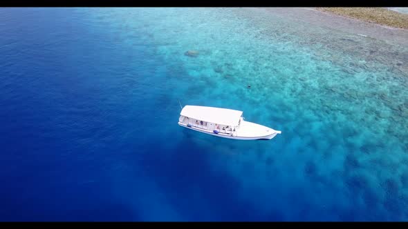 Aerial flying over scenery of beautiful seashore beach voyage by clear lagoon with white sand backgr