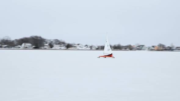 Ice sailing on a beautiful crisp day on a wide frozen bay.