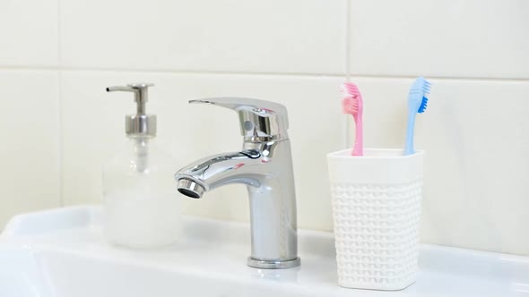 Woman Changing Old Brushes for New Modern Ultrasonic Electric Toothbrush