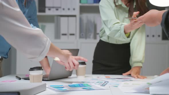 Close up hands of businessman and woman people group meeting brainstorm and work in office at night.