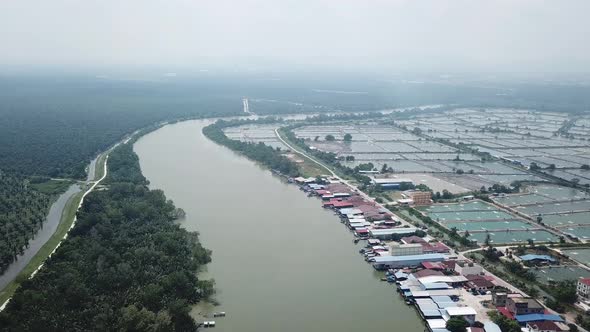 Aerial view fishing village beside fish farm