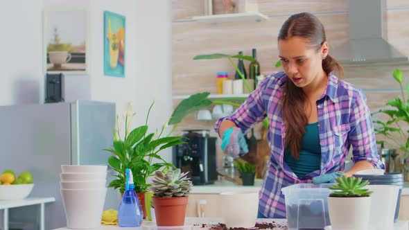 Woman Caring for Home Flowers