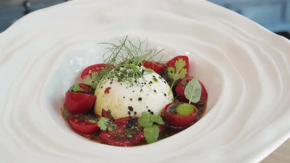 Salad with Burrata Mozzarella Cheese Tomatoes and Leafs of Salad