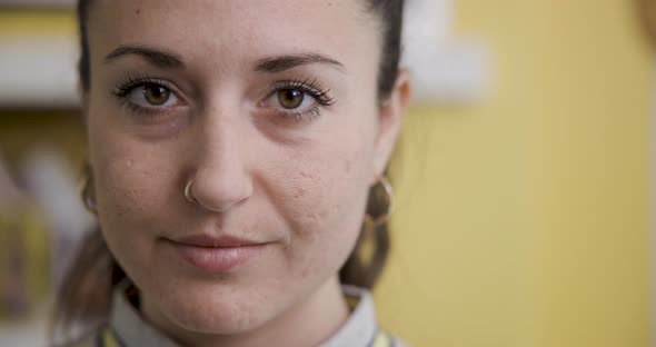 Portrait of young woman at home smiling and looking at camera