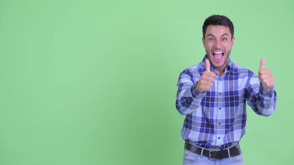 Happy Young Hispanic Man Showing Something and Looking Excited