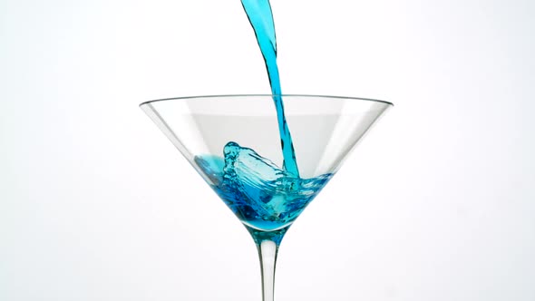Pouring cocktail into martini glass, Slow Motion