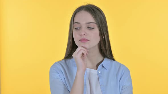 Casual Young Woman Thinking New Idea, Yellow Background