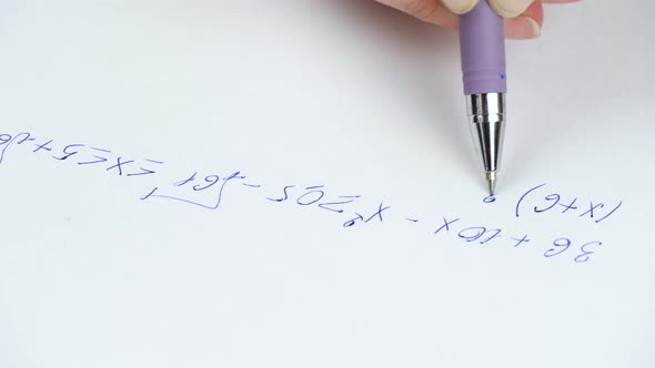 çClose-up of a Fountain Pen Writing Mathematical Formulas on Paper. Solving Equations, Education and