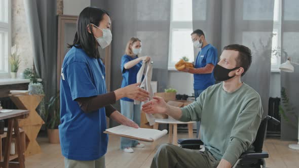 Volunteer Worker and Disabled Man Shaking Hands