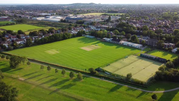 Drone shot flying over Canons Park sports ground and recreational park, London