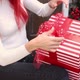 Closeup girls hands packing a Christmas present with bow on the porch - VideoHive Item for Sale