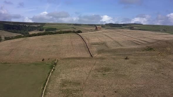 Aerial tracking forward towards St Catherine's Chapel, near Weymouth, and  the village of Abbotsbury