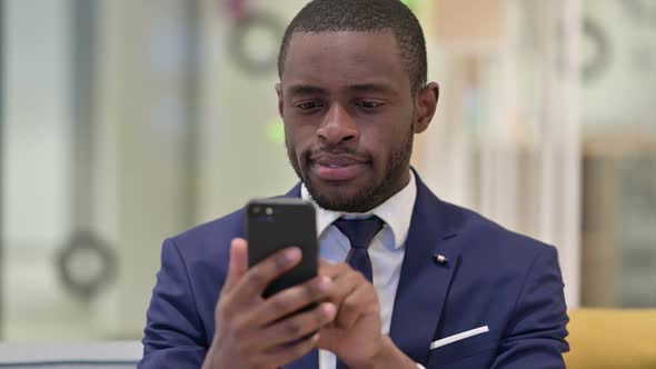 Portrait of African Businessman Using Smartphone