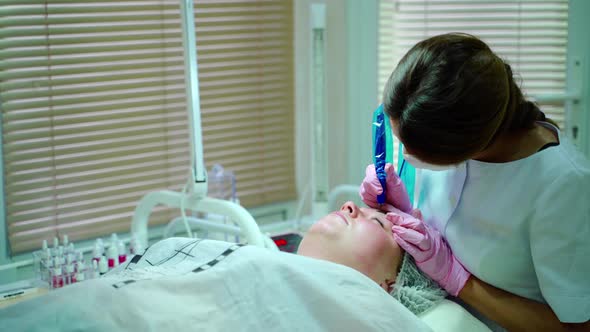 Cosmetologist Applying Permanent Make Up on Eyebrows