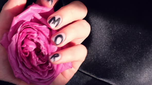 AMOR Word on Nails Manicure Hold Pink Rose Flower on Black Silk Fabric