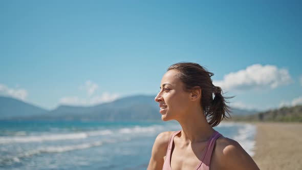 Young Active Sporty Athlete Smiling Woman is Taking a Break After Making Running and Jogging Workout