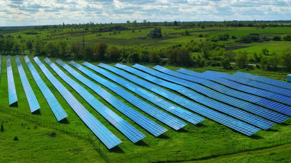 Drone Shot Blue Sun Panels Rows in Green Field