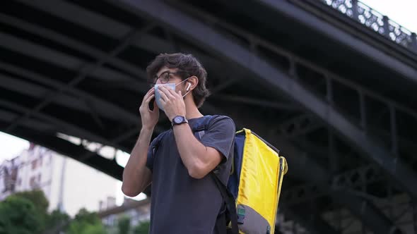 Messenger Puts on Medical Protective Mask Side View