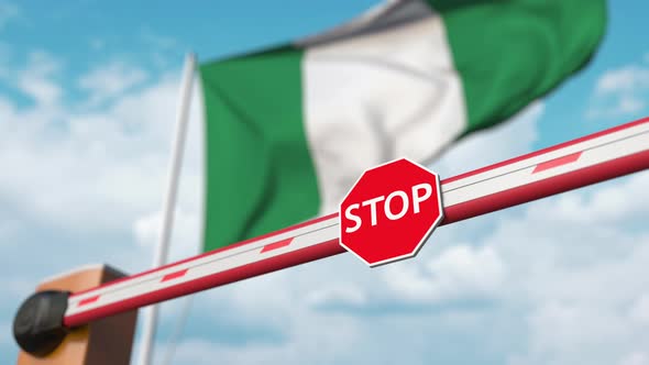 Opening Boom Barrier with Stop Sign Against the Nigerian Flag alt