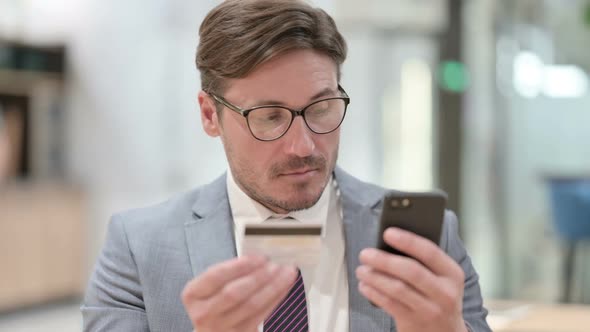 Portrait of Businessman Making Online Payment on Smartphone