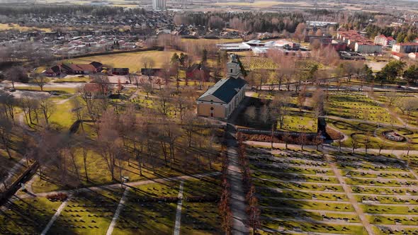 Drone flying away from church panning up on small town